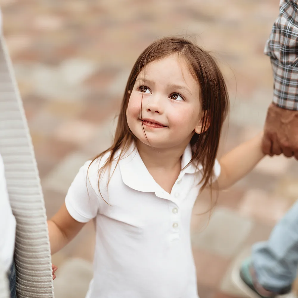 Child smiling up at mom at a Little Newtons daycare.