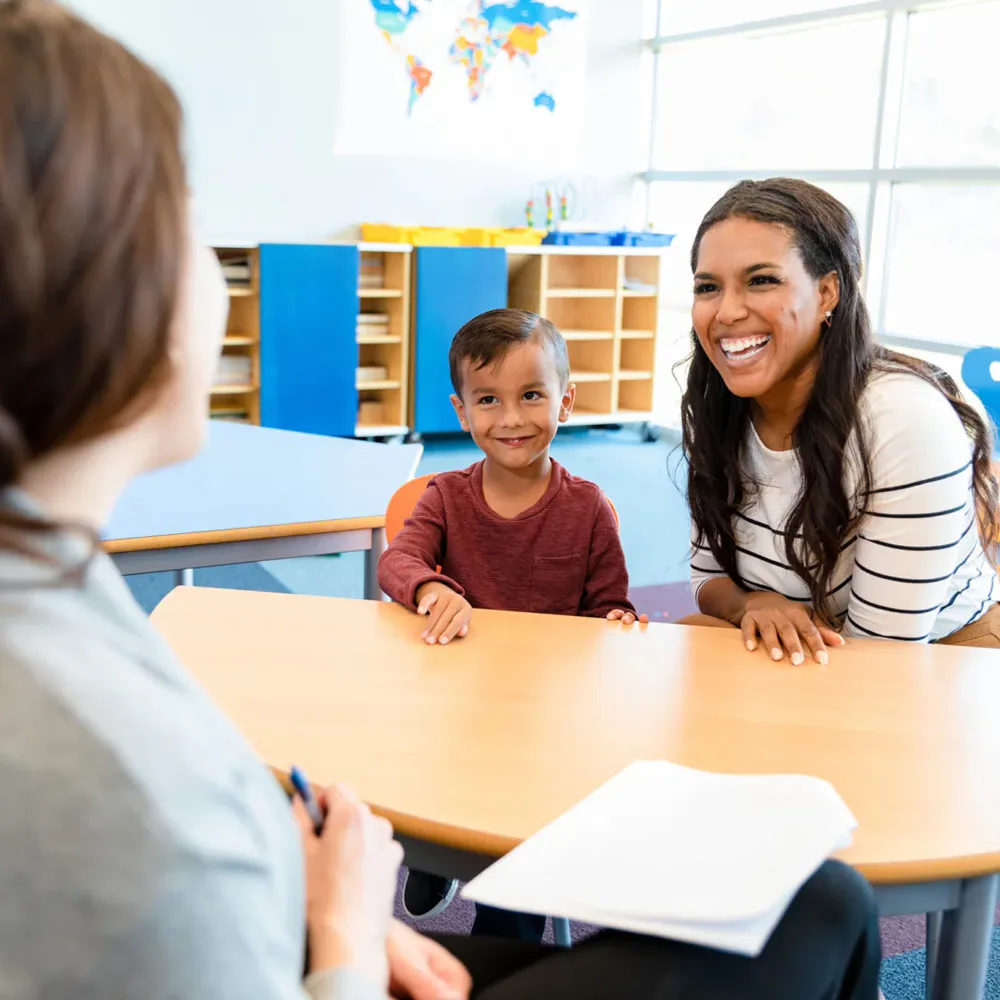 A child and an adult at a table in a Little Newtons daycare