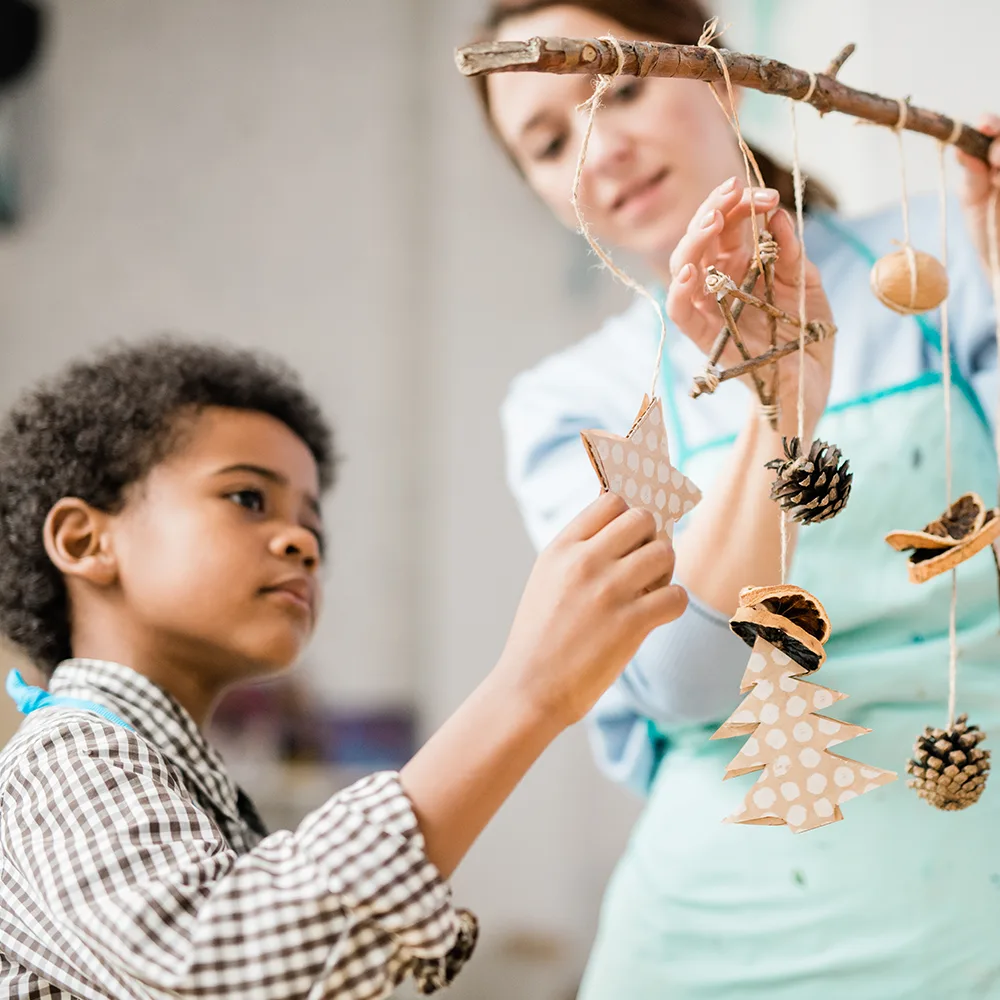 A child looking at stars hanging on string from a branch in a Little Newtons daycare