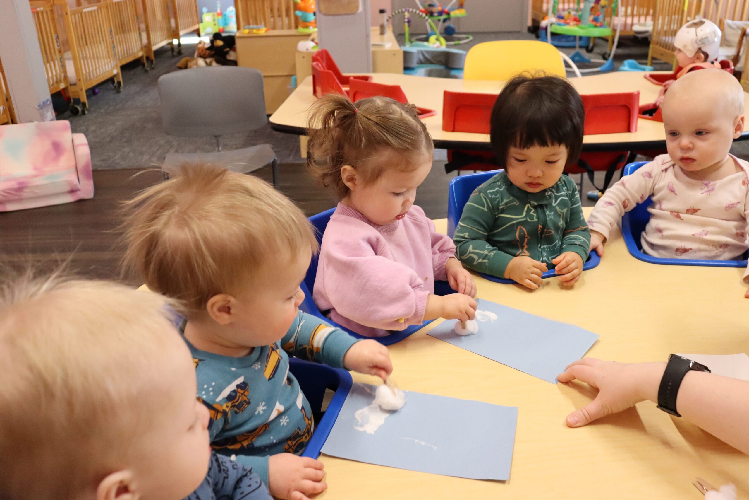 little newtons classroom with toddlers at a table in a learning setting