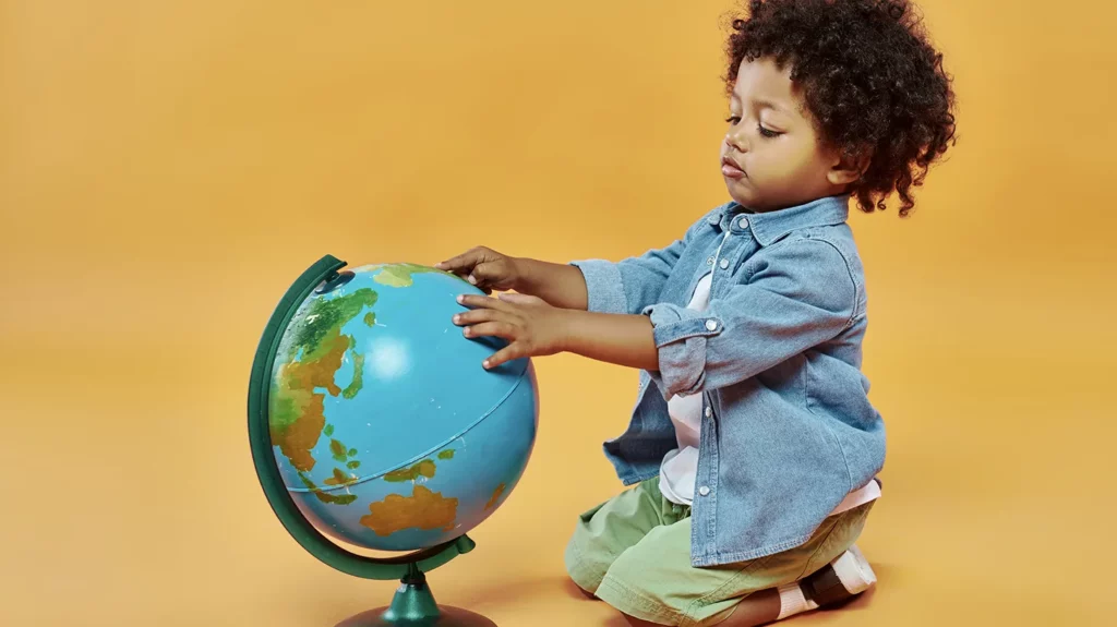 Kid touching a globe