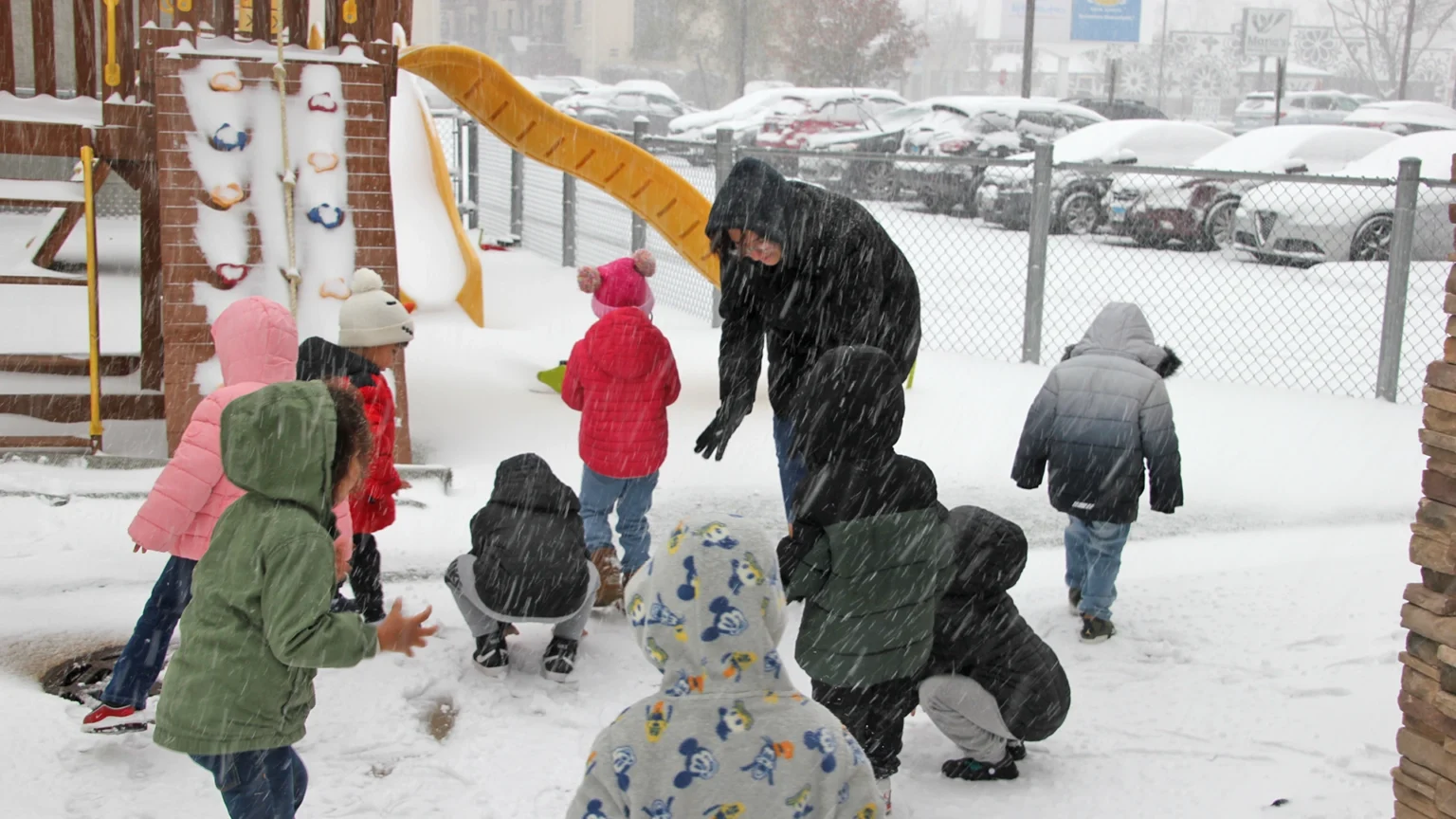 Children playing outside in the snow at a Little Newtons daycare