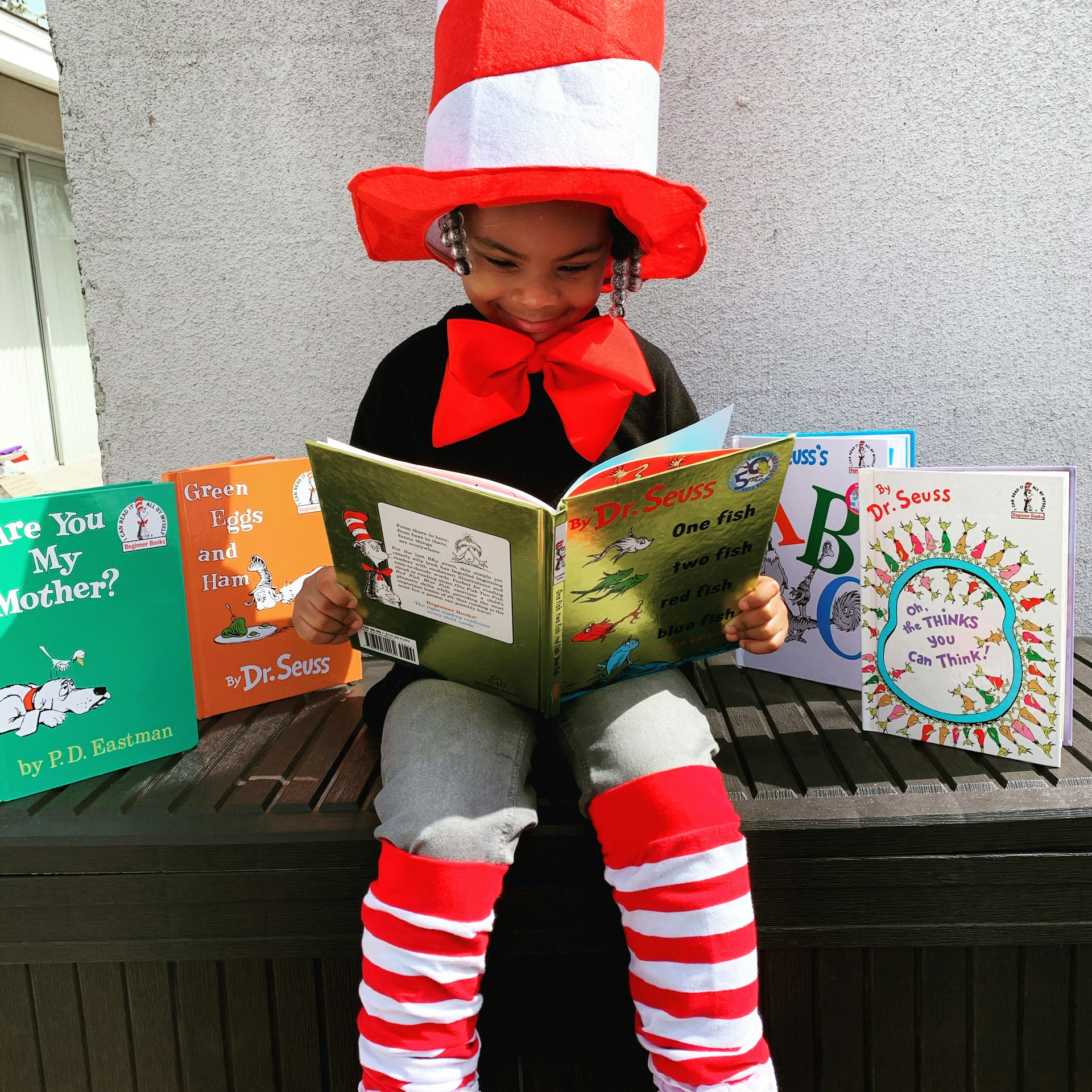 Preschool girl reading book